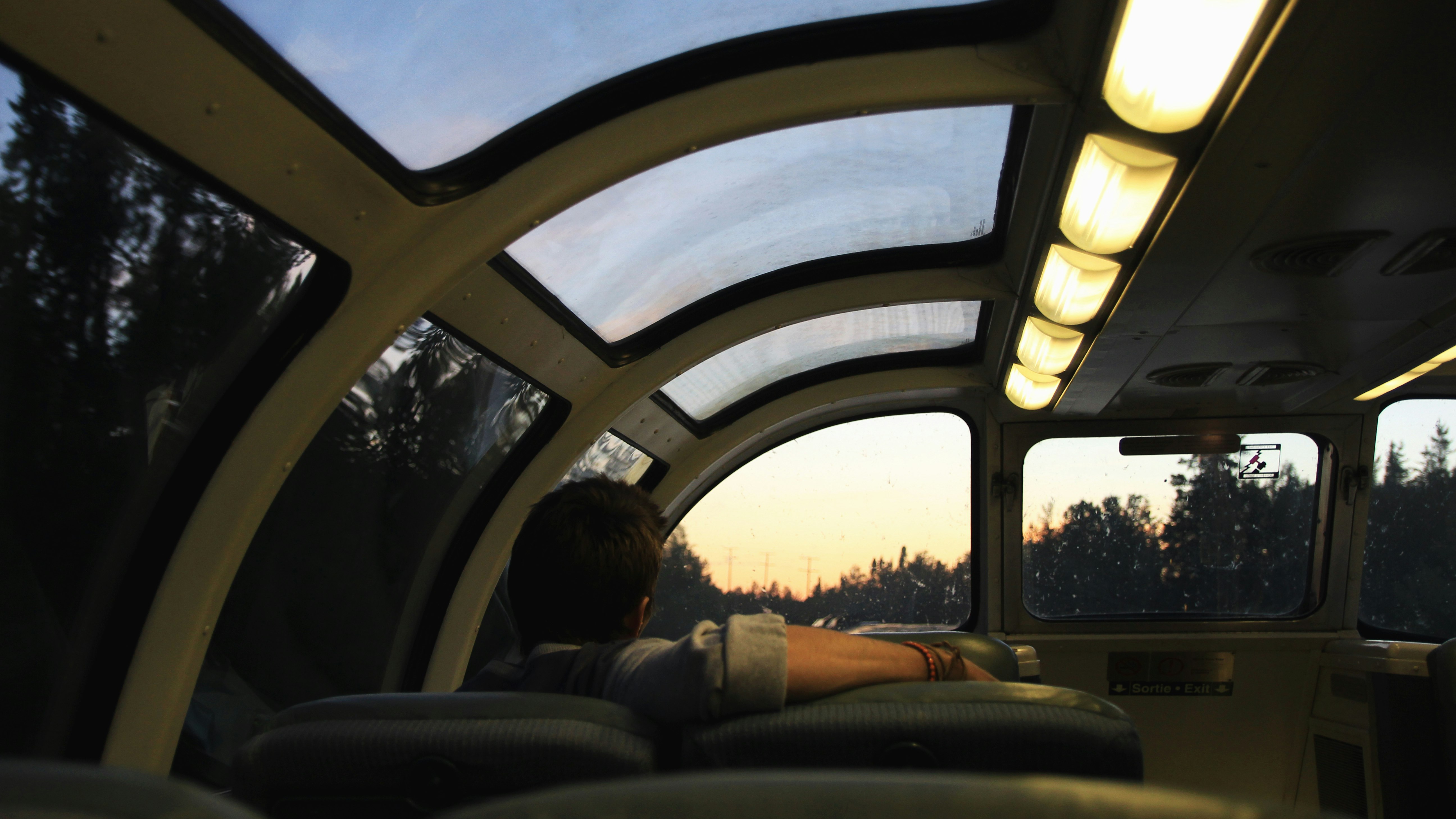 man leaning right arm on empty seat